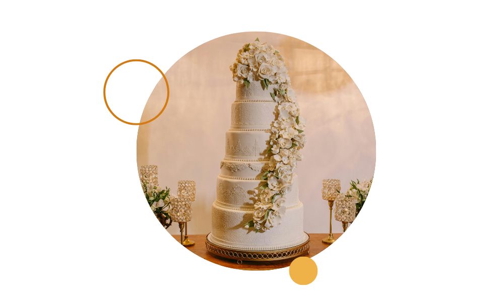 Tarta de varios pisos decorada con flores blancas y detalles elegantes en estilo de pastelería profesional para eventos y bodas.